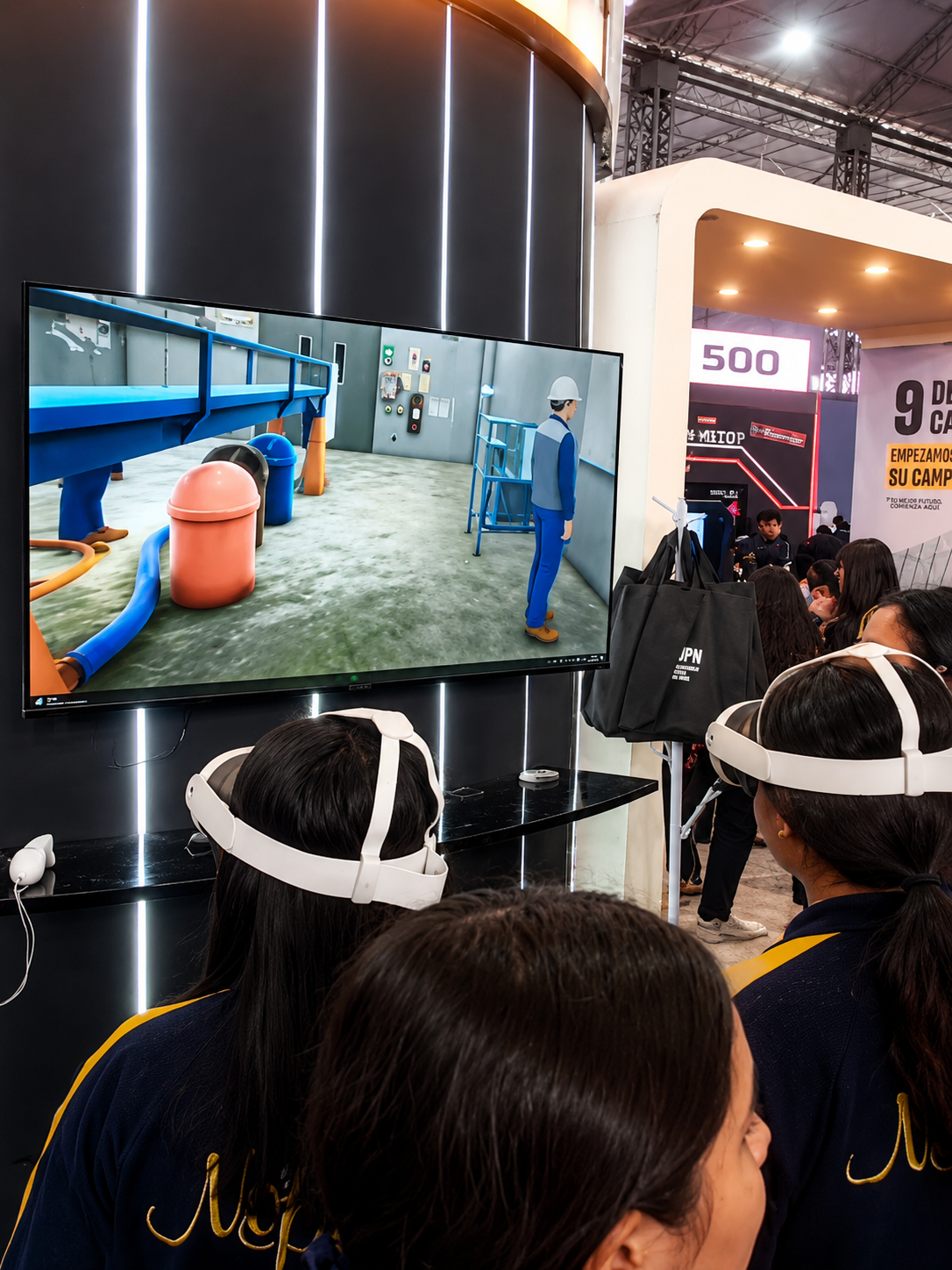 Estudiantes con visores VR viendo entorno 3D en pantalla